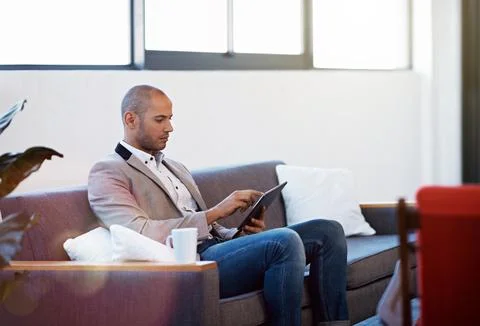 Creative, man and scroll in office with tablet, research or check AI software Stock-Fotos