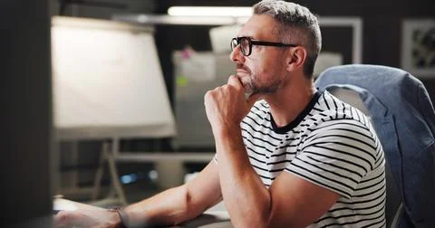 Creative, man and thinking by computer in office for project ideas and design Foto stock