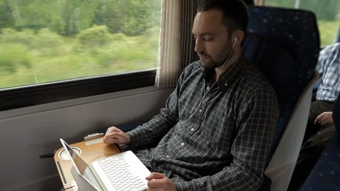 Creative man designer working on his laptop computer in a train. 스톡 동영상 115984761