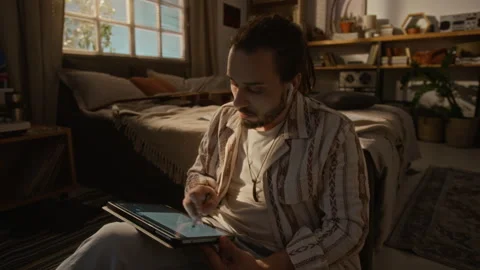 Creative Man Drawing on Digital Tablet while Working from Home Stock Footage 337501327
