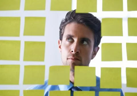 Creative man, face and thinking for sticky note, brainstorming or planning tasks Stock Photos