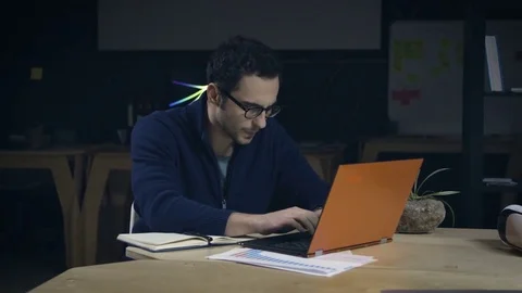 Creative man in glasses working late at night Stock Footage 72574170