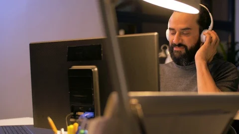 Creative man with headphones working at office Stock Footage 87124232