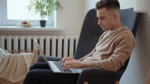 Creative man in home office working on a laptop. Millennial guy Stock Footage 127346298
