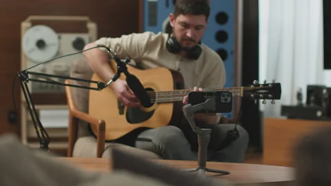 Creative man play guitar record music tutorial or video for social networks on 動画素材 172218004