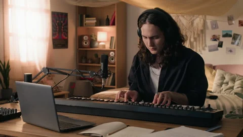 Creative Man Playing Midi Keyboard, Using Laptop in Home Music Studio Stock Footage 338067433