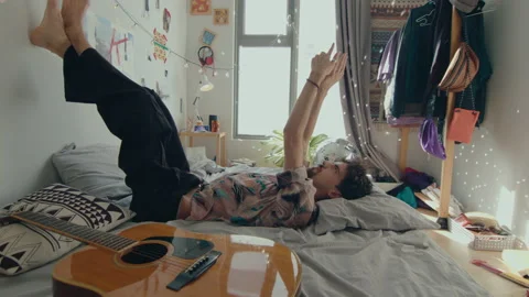 Creative Man Resting on Bed at Home Stock Footage 235658204