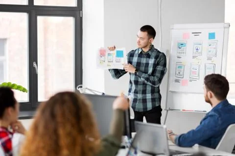 Creative man showing user interface at office Stock Photos