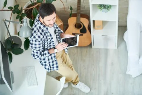 Creative man with tablet in studio Stock Photos