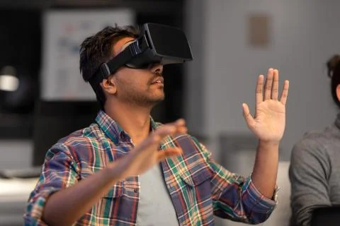 Creative man in virtual reality headset at office Stock Photos