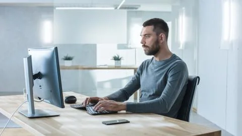 Creative Man Working on the Computer in the Bright Modern Office. Stock Photos