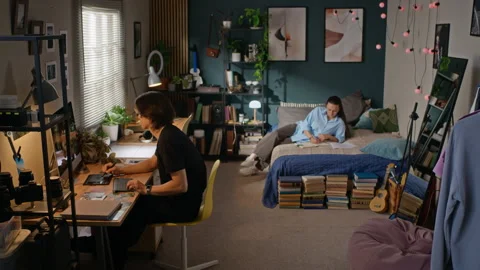 Creative Man Working on Computer While Woman Studying on Bed Stock Footage 341939542