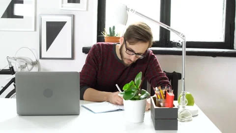 Creative manager writing idea sitting in office Stock Footage 86158553