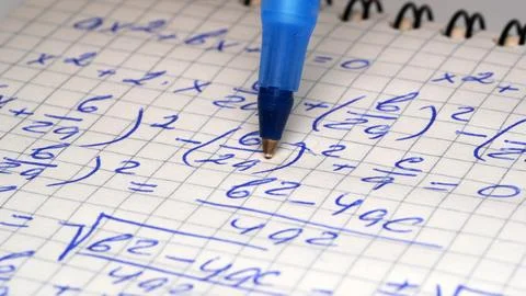 Creative math practice with ink on graph paper Stock Photos
