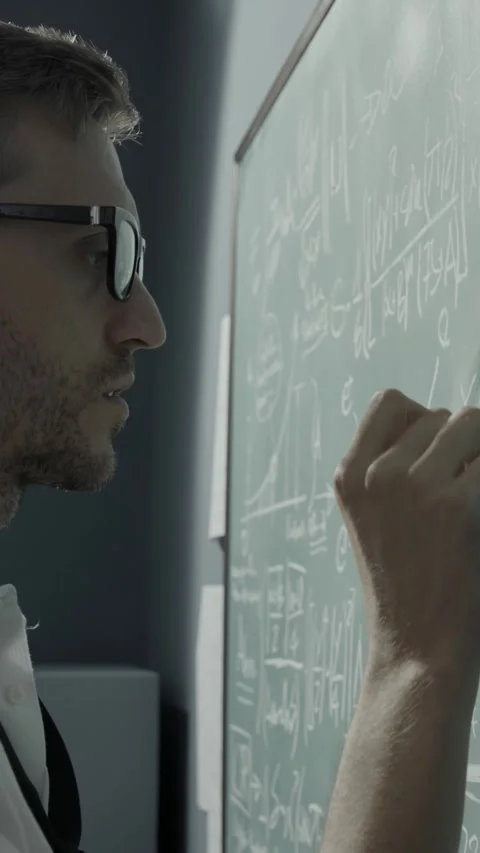 Creative mathematician writing formulas on the chalkboard Stock Footage 293678781