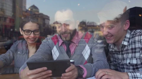 Creative meeting in a cafe of two young men and a girl Stock Footage 85223963