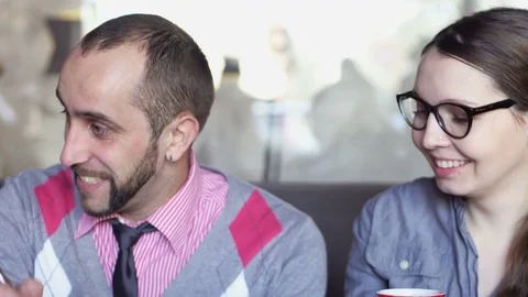 Creative meeting in a cafe of two young men and a girl Stock-Footage 85224638