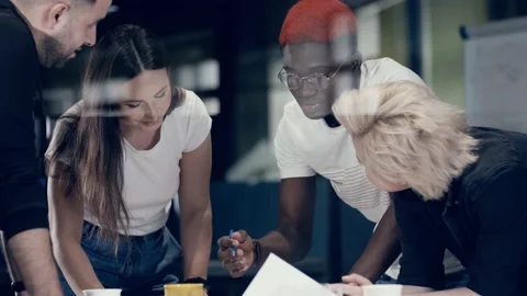 Creative meeting of a multinational team of architects and designers discussing Stock Footage 140918859