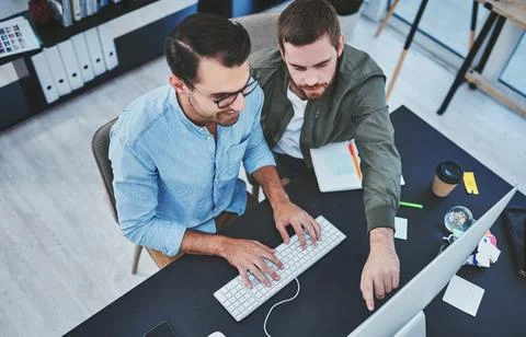Creative, men and typing with computer in office for internship, technical Stock Photos