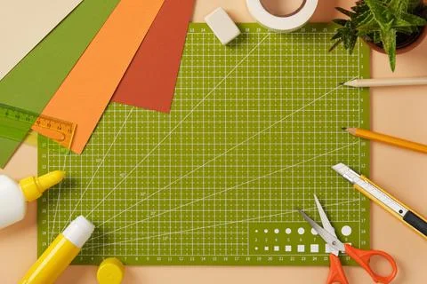 Creative mess on the paper crafting table. Colored sheets of paper, glue, p.. Stock Photos