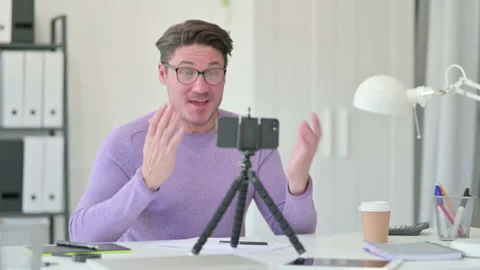 Creative Middle Aged Man Blogging in Office, Video Recording Video stock 143570758