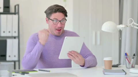 Creative Middle Aged Man Celebrating Success on Tablet 스톡 동영상 143564984