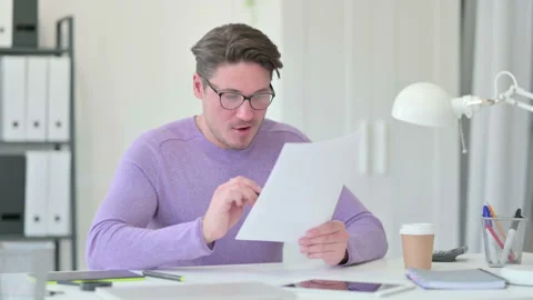 Creative Middle Aged Man with Documents Celebrating Success Stock Footage 143566389