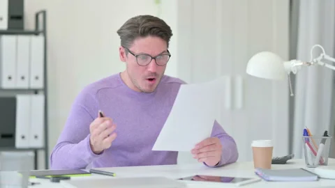 Creative Middle Aged Man with Documents Reacting to Loss Stock Footage 143569888