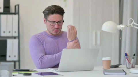 Creative Middle Aged Man with Laptop having Wrist Pain in Office Video stock 143565061