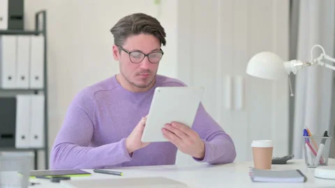 Creative Middle Aged Man Working on Tablet Video stock 143563422