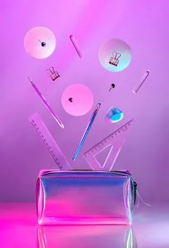 Creative minimal composition made with school supplies flying in the air in neon Stock Photos