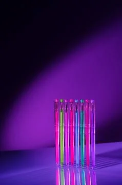 Creative minimal composition made with school supplies flying in the air in neon Foto stock