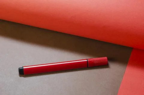 Creative minimalist composition with a red felt-tip pen on a two-color backgr Stock Photos