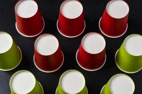 Creative minimalistic composition, pattern of inverted paper cups on a black  Stock Photos
