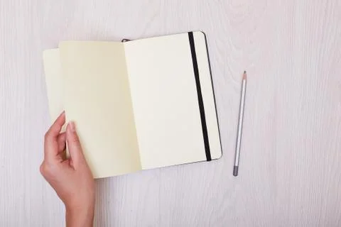 Creative mock up layout made with copy space on table. Open sketchbook. Hand Stock Photos