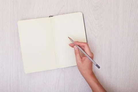 Creative mock up layout made with copy space on table. Open sketchbook. Hand Stock Photos