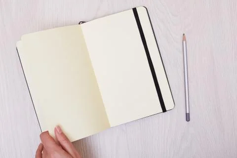 Creative mock up layout made with copy space on table. Open sketchbook. Hand Stock Photos