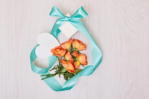 Creative mock up made of roses  with copy space on table. Empty sheet of card Stock Photos