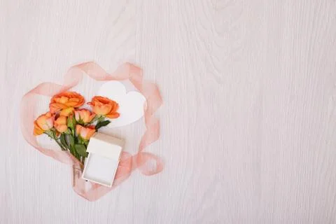 Creative mock up made of roses  with copy space on table. Empty sheet of card Stock Photos