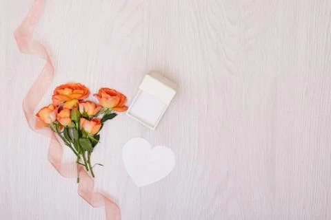 Creative mock up made of roses  with copy space on table. Empty sheet of card Stock Photos