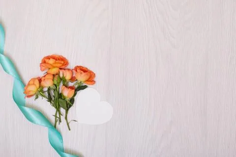 Creative mock up made of roses  with copy space on table. Empty sheet of card Stock Photos