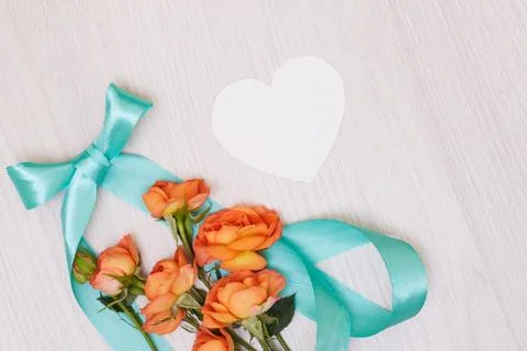 Creative mock up made of roses  with copy space on table. Empty sheet of card Stock Photos
