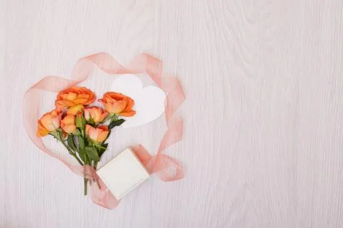 Creative mock up made of roses  with copy space on table. Empty sheet of card Stock Photos