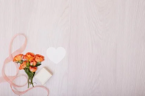 Creative mock up made of roses  with copy space on table. Empty sheet of card Stock Photos