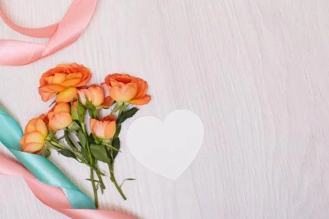 Creative mock up made of roses  with copy space on table. Empty sheet of card Stock Photos
