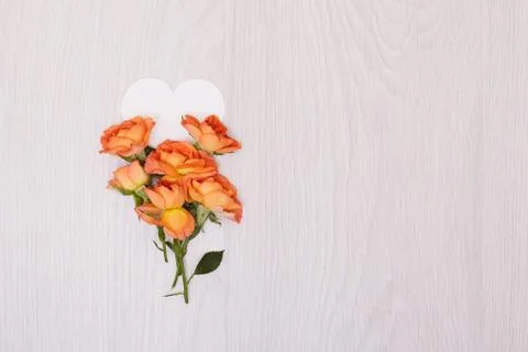 Creative mock up made of roses  with copy space on table. Empty sheet of card Stock Photos