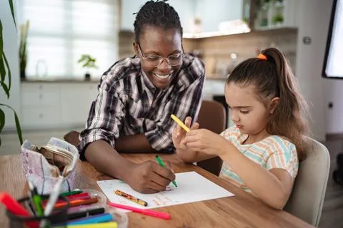Creative moments shared between a child and an adult at home Stock Photos