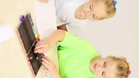 Creative moments shared by two young artists in a vibrant classroom 스톡 동영상 296332305