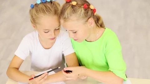 Creative moments shared by two young friends at a colorful workspace Stock Footage 296332336