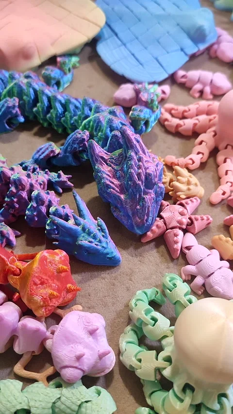 Creative multi-colored models printed on 3D printer from molten plastic Vertical Stock Footage 303359676